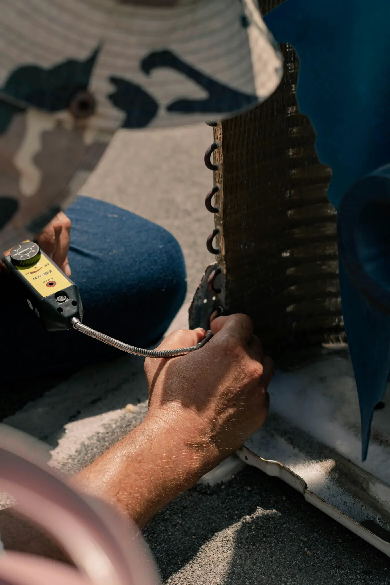 Technician using digital multimeter to test electrical components