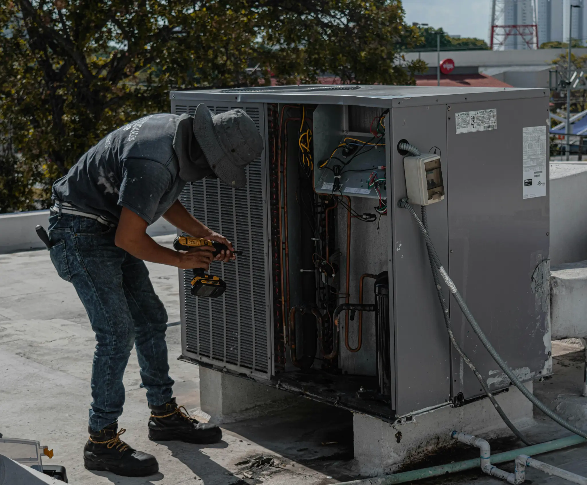 HVAC technician performing maintenance on outdoor unit
